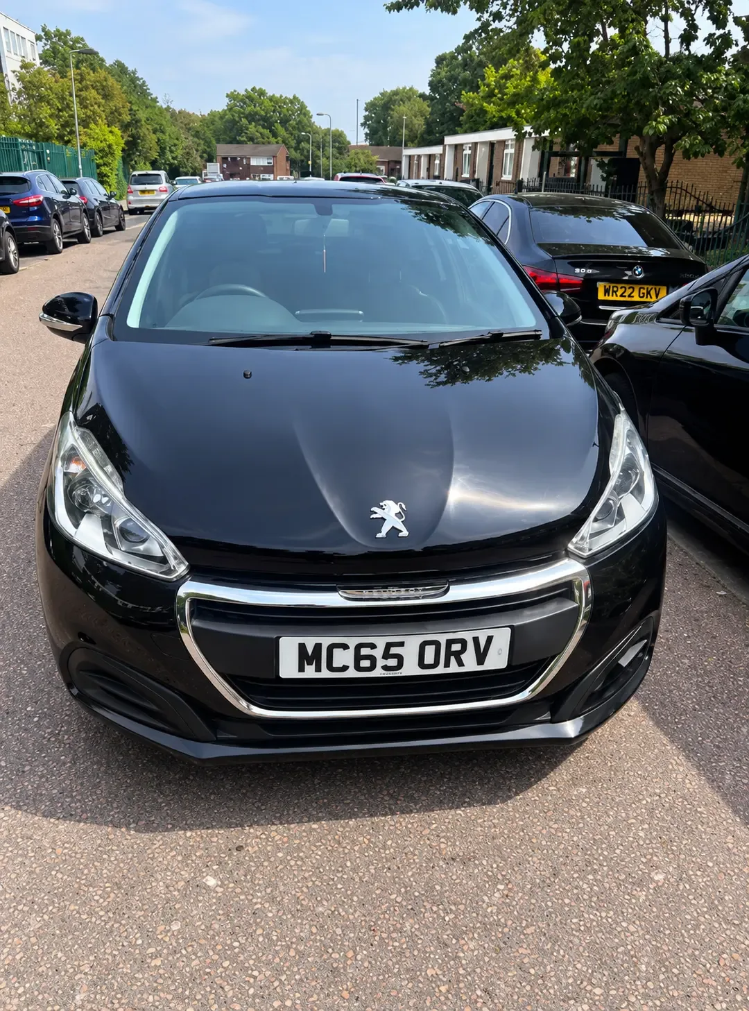 Peugeot 208 front view showing grille, headlights and registration MC65 ORV