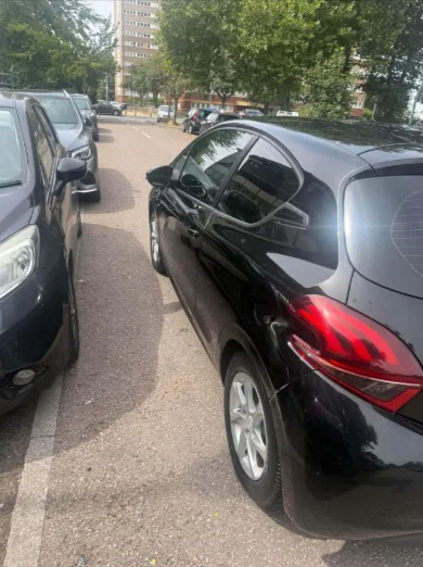 Peugeot 208 rear three quarter view in black