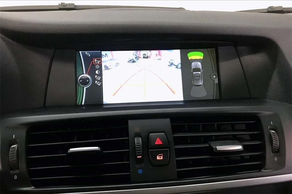 BMW iDrive screen showing the reversing camera and parking sensors