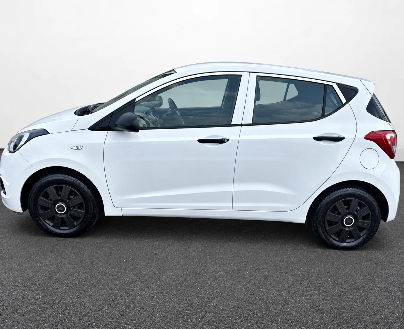 White Hyundai i10, side profile view