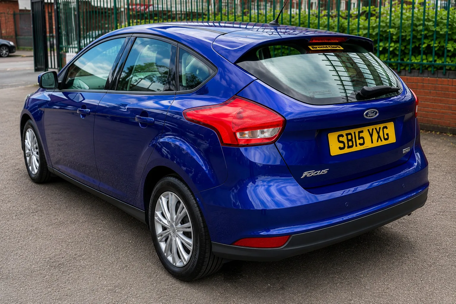 Blue Ford Focus rear three quarter view