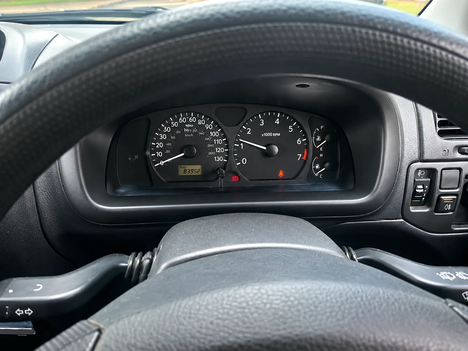 Suzuki Wagon R+ instrument cluster showing 83,952 miles on the odometer