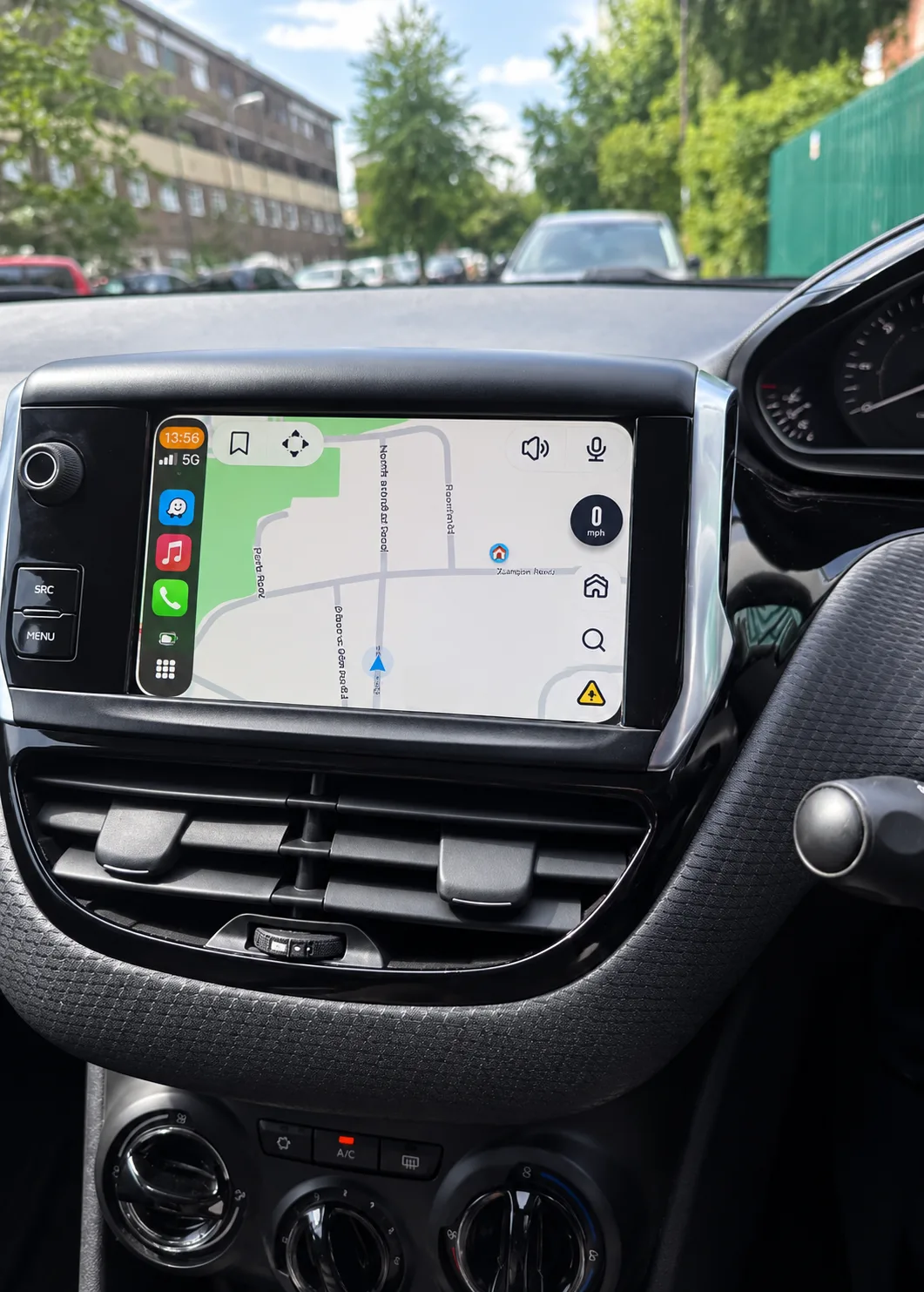 Peugeot 208 touchscreen infotainment display with smartphone connectivity and air conditioning controls