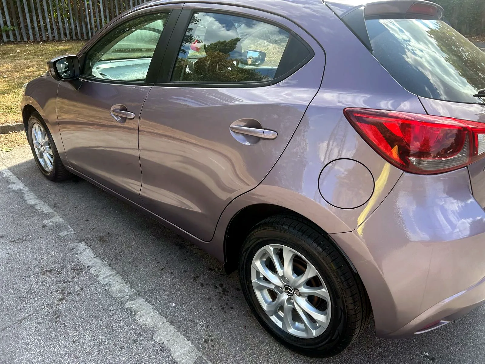 Mazda2 SE-L rear side exterior view with alloy wheel and rear light
